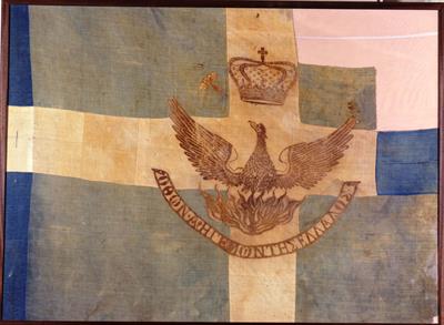 Blue and White Flag of the Ottonian period depicting a phoenix with a crown, 1833-1862. It bears the inscription: ΟΘΩΝ Α&#039; ΗΓΕΜΩΝ ΤΗΣ ΕΛΛΑΔΟΣ (Otto I Ruler of Greece).