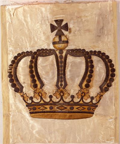 The crown from the royal flag that was raised at the steam boat &quot;Amalia&quot; until October 12th, 1862. During the expulsion of Otto and Amalia it accompanied them in the boat that would take them to the English ship.