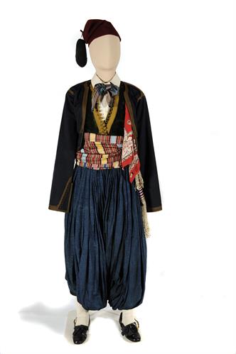 Male traditional costume from Spetses island. It belonged to the freedom-fighter Dimitrios Goudis. It consists of a pleated breeches of silk (&quot;vraka&quot;), a cotton shirt, two felt waistcoats, a woven cummerbund (&quot;zonari&quot;), a red fez, a silk kerchief and leat