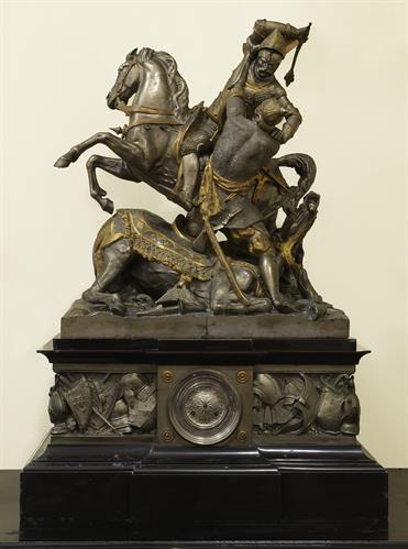 Clock for fireplace, made of gilded bronze, accompanied by two candlesticks with two decorative brass statuettes. The theme of its decoration is inspired by the sculptural composition of T. Gechter (1833) and depicts the Battle of Poitiers (732 AD) betwee