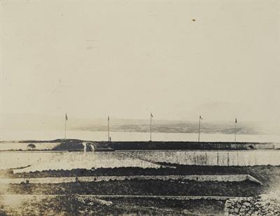 Crete. The flags of the four Great Powers and the Turkish flag on the islet of Souda. Photograph, 1909.
