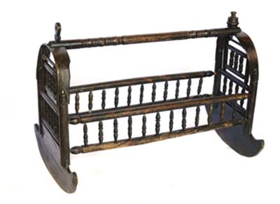 Wooden cradle painted green, baring woodcut decoration, Lazaros Koundouriotis Historic Residence on Hydra Island
