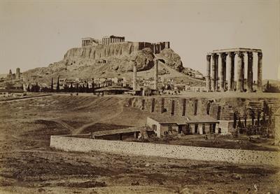 The Acropolis of Athens and the temple of Olympian Zeus, seen from the southwest of the Olympeion. Part of the city is depicted from the south of the Odeon of Herodes Atticus to the area north of Hadrian&#039;s Gate. Photograph, 1880.