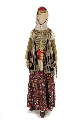 Bridal costume of the Attica villages. It cosists of a white cotton tunic (&quot;pokamisso&quot;) with a fully embroidered multi-colored hem (&quot;foundi&quot;), a short waistcoat (&quot;tzakos&quot;), the Byzantine &quot;tzitzakion&quot;, with gold-embroidered sleeves and a fret pattern all a